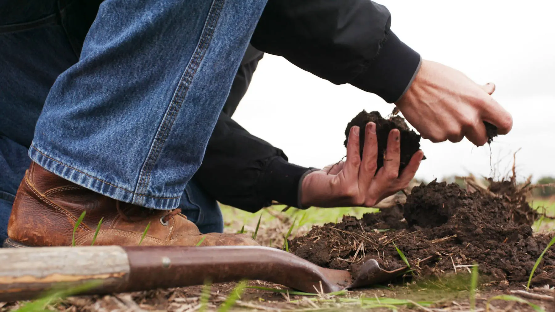 farmer digging in field, achieving a sustainable future through new innovations in farming