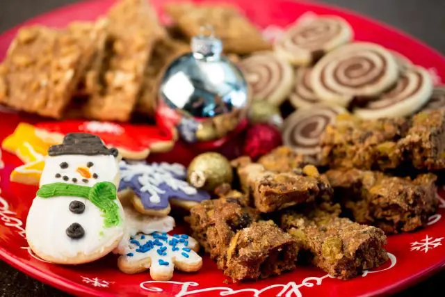 Holiday snowman sugar cookies on a festive holiday platter