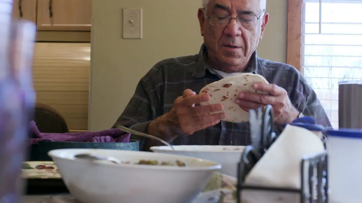 man holding tortilla