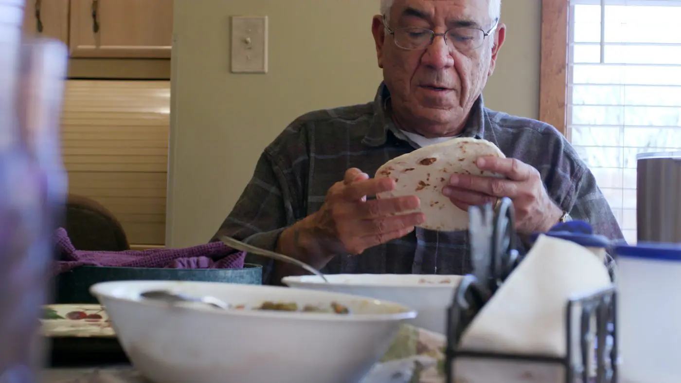 man holding tortilla