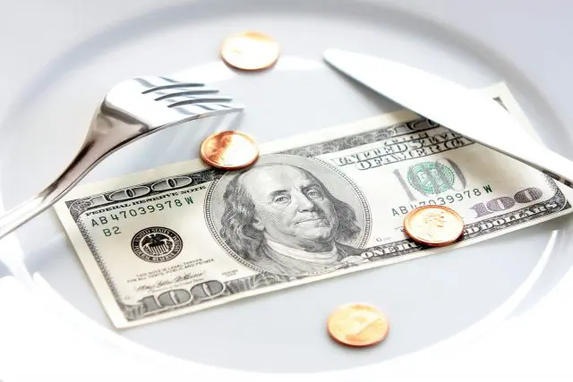 Photo: Money on dinner plate.