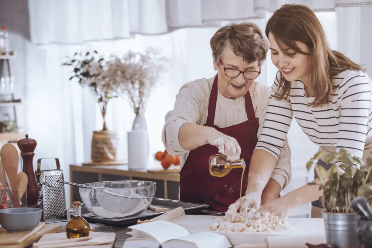 Grandmother and granddaughter making cherished family recipes.