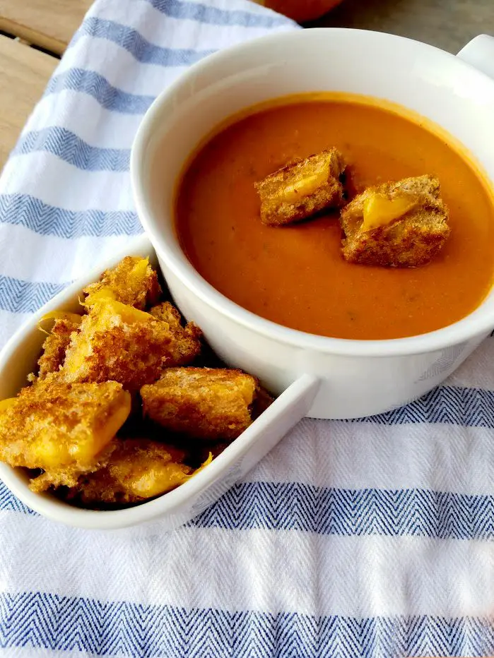 Warm up with a cup of tomato soup topped with crispy grilled cheese croutons!