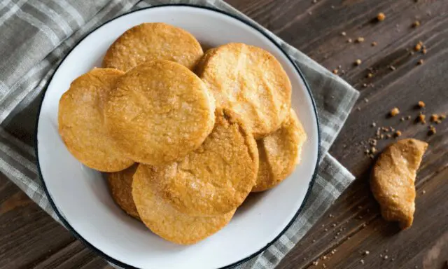 sugar cookies arranged on a plate with a plaid dish towel. sugar cookie recipes