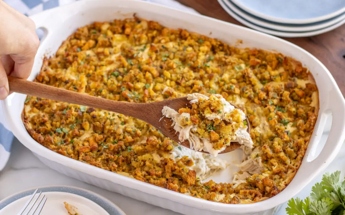 Creamy Chicken Stuffing Casserole in a serving dish with a spoon dipped into it.