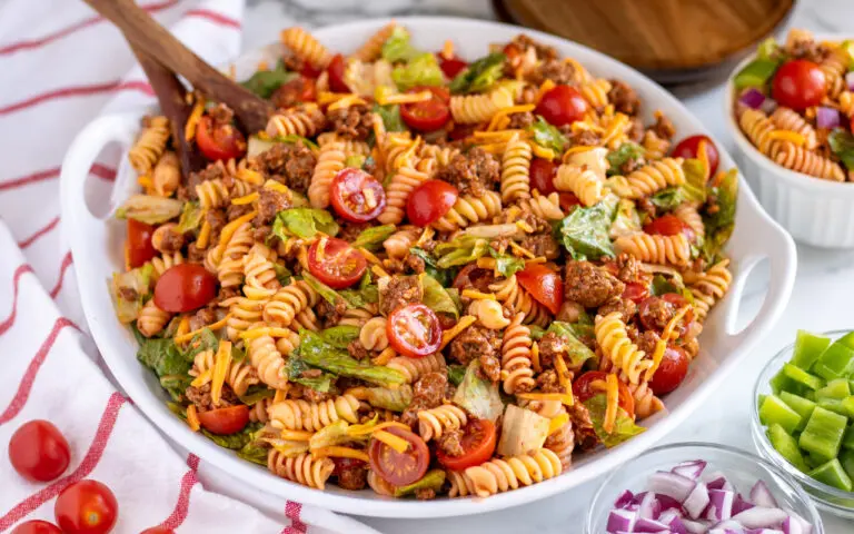 Taco Pasta salad in a bowl with a serving spoon in the dish.