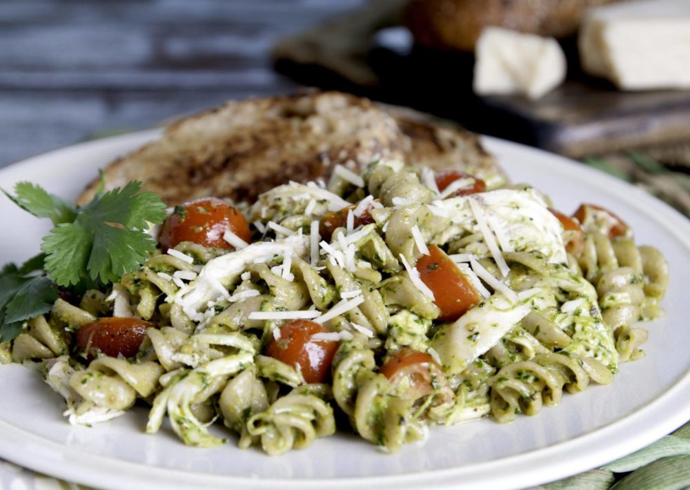 Cilantro Pesto Pasta with Chicken served with whole wheat toast and a sprig of basil