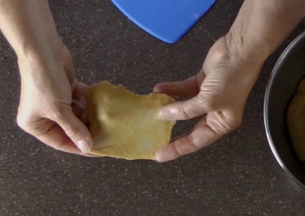 A bread is sufficiently kneaded when a small pinch of dough can be stretched and a small film (of gluten) forms.
