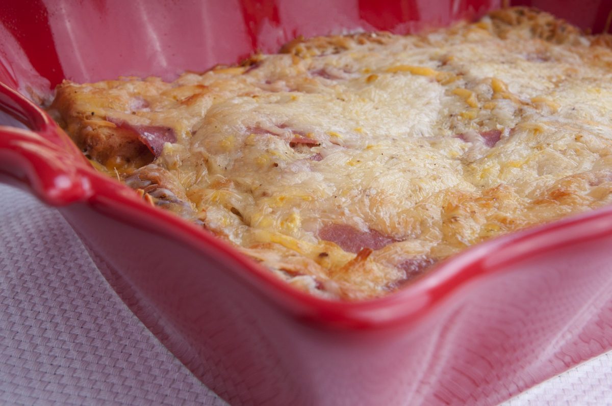 Ham and Swiss Breakfast Casserole served in a red dish