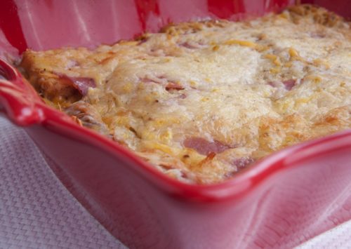 Ham and Swiss Breakfast Casserole served in a red dish
