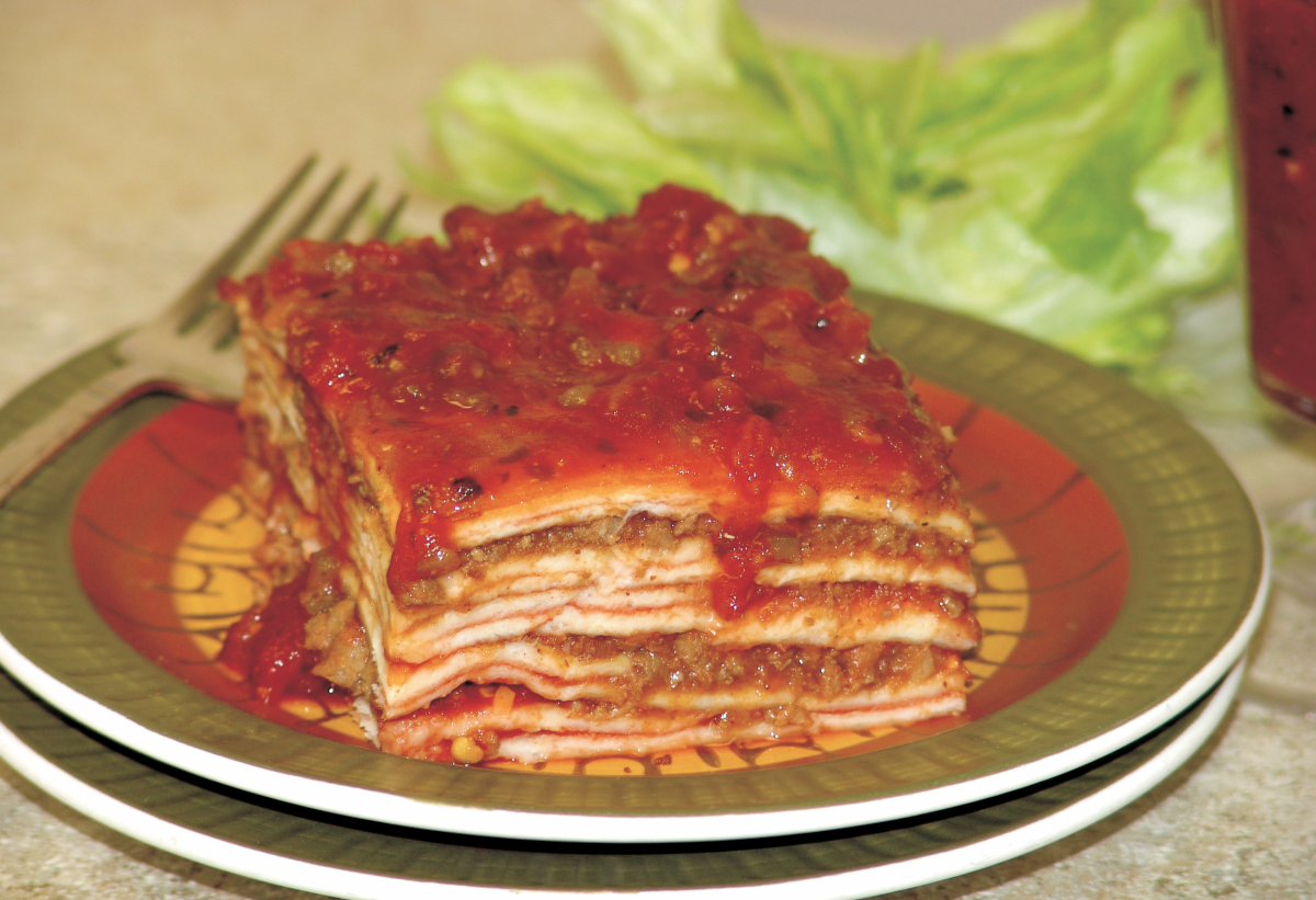 Layered Enchilada Casserole served on plates with a fork