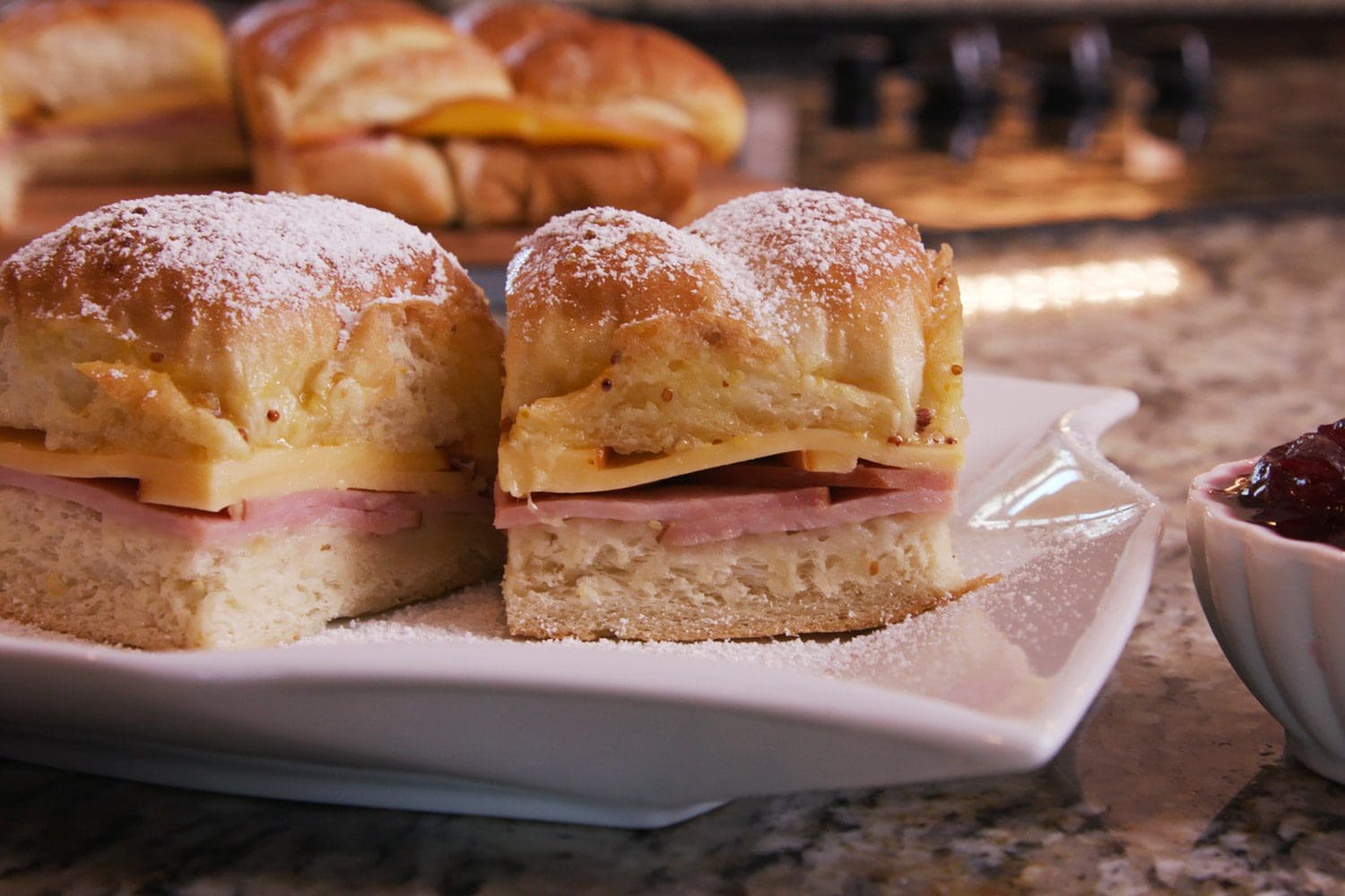 Monte Cristo Sliders served on a plate complete with raspberry jelly.