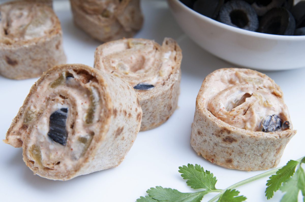 Whole Wheat Tortilla Pinwheels served with black olives and a sprig of basil