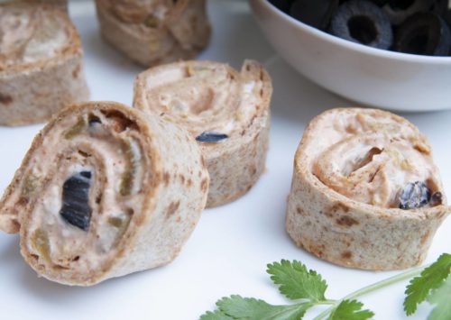 Whole Wheat Tortilla Pinwheels served with black olives and a sprig of basil