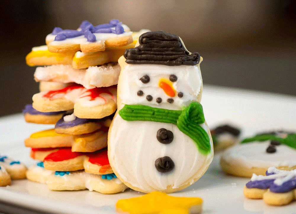 Homemade holiday sugar snowman cookies of all different holiday shapes