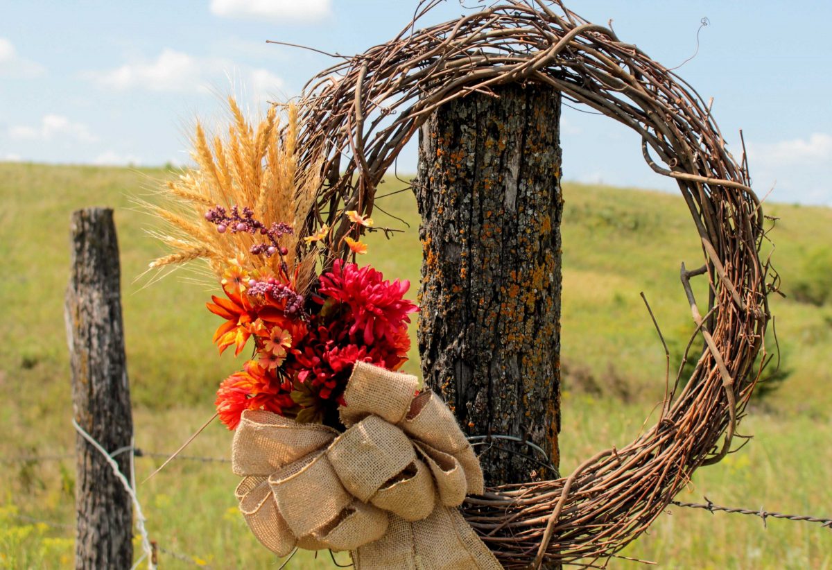 DIY Rustic Fall Wreath hung in front of a Kansas pasture