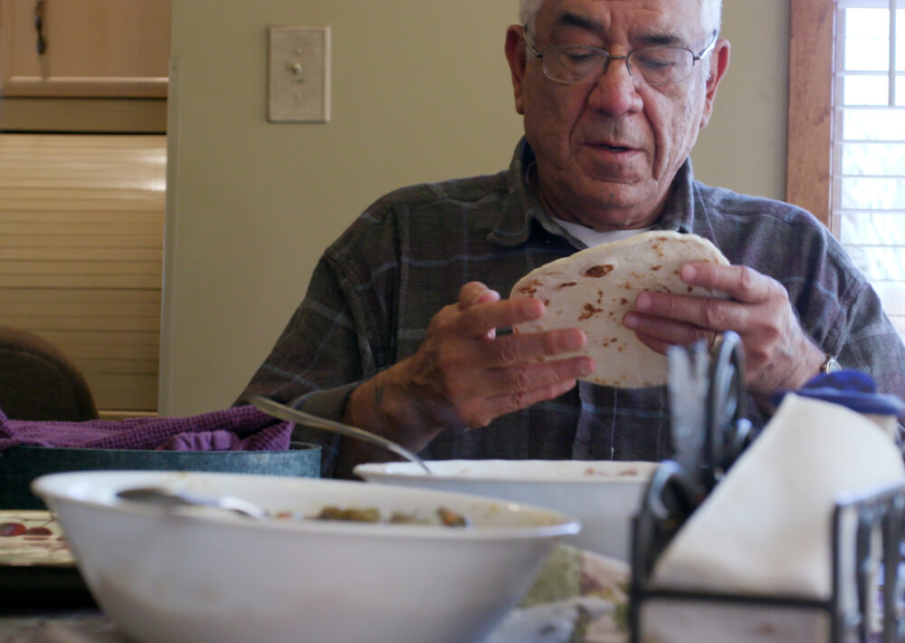 man holding tortilla