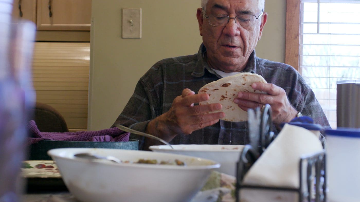 man holding tortilla
