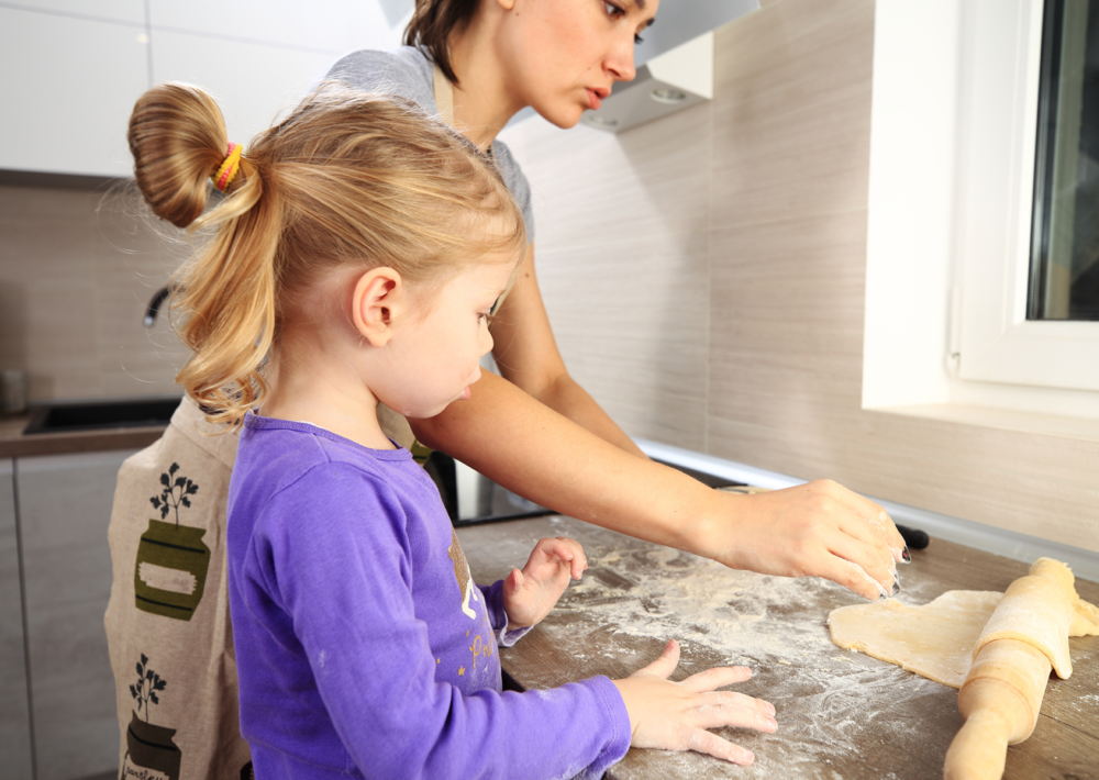Photo: Mom and daughter baking in the kitchen.
