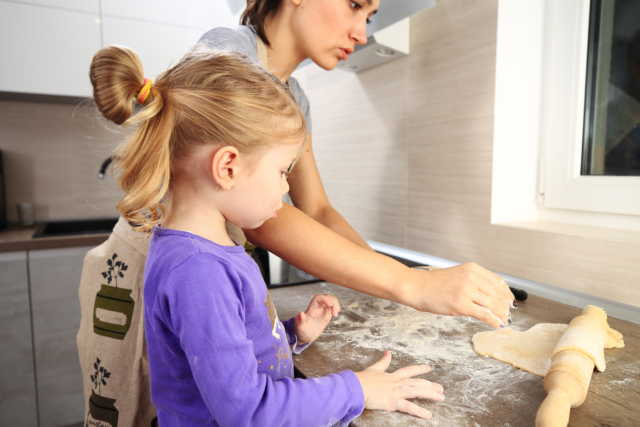 Photo: Mom and daughter baking in the kitchen.