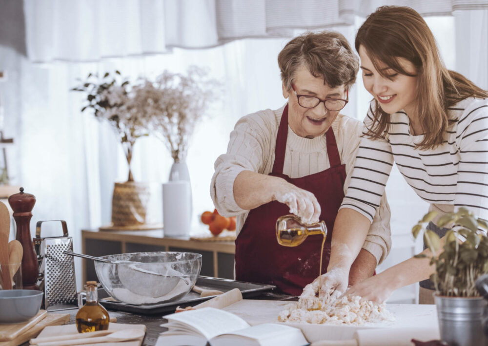 Grandmother and granddaughter making cherished family recipes.