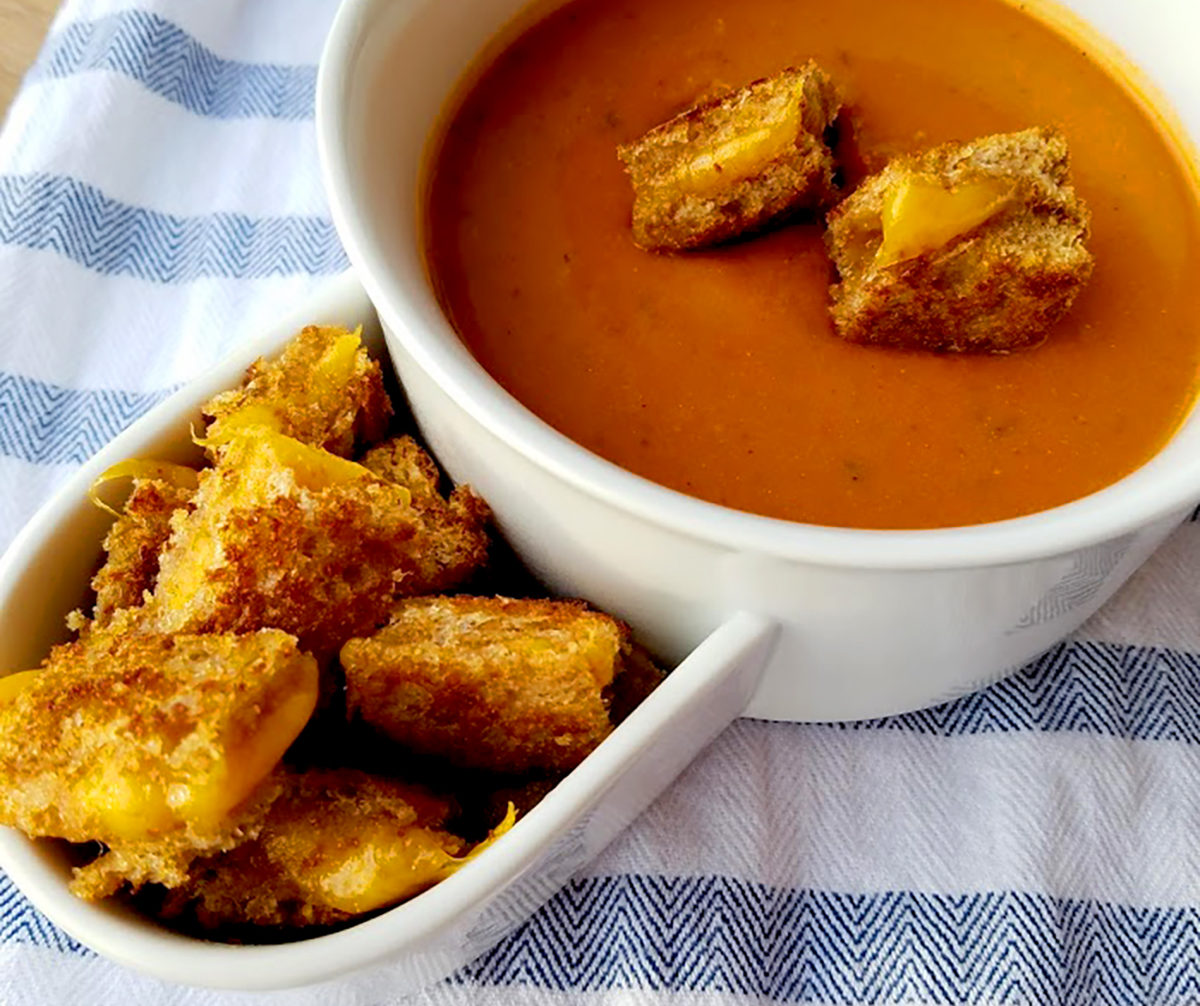 Warm up with a cup of tomato soup topped with crispy grilled cheese croutons!