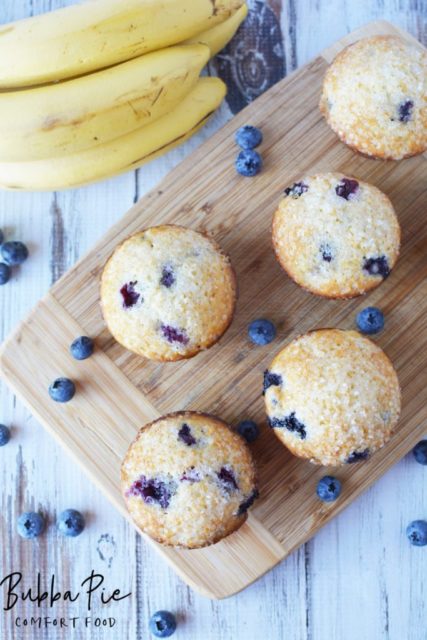 Easy Banana Blueberry Muffins on wood cutting board