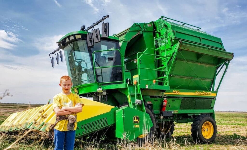 Image: Burgess son in front of combine.