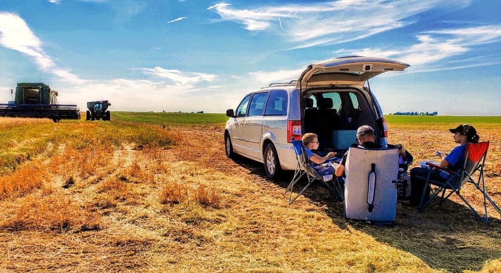 Photo: Burgess family eating lunch in the field.