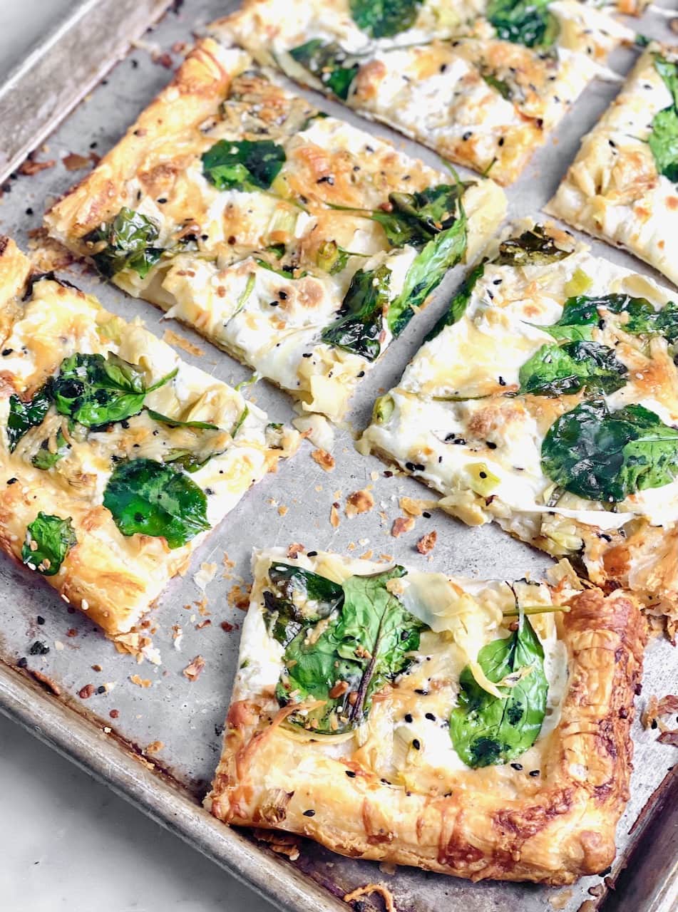 Spinach Alfredo Pizza on a baking pan perfect for Super Bowl Recipe Roundup