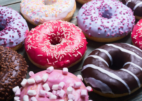 Colorful donuts arranged on a plate to celebrate National Donut Day