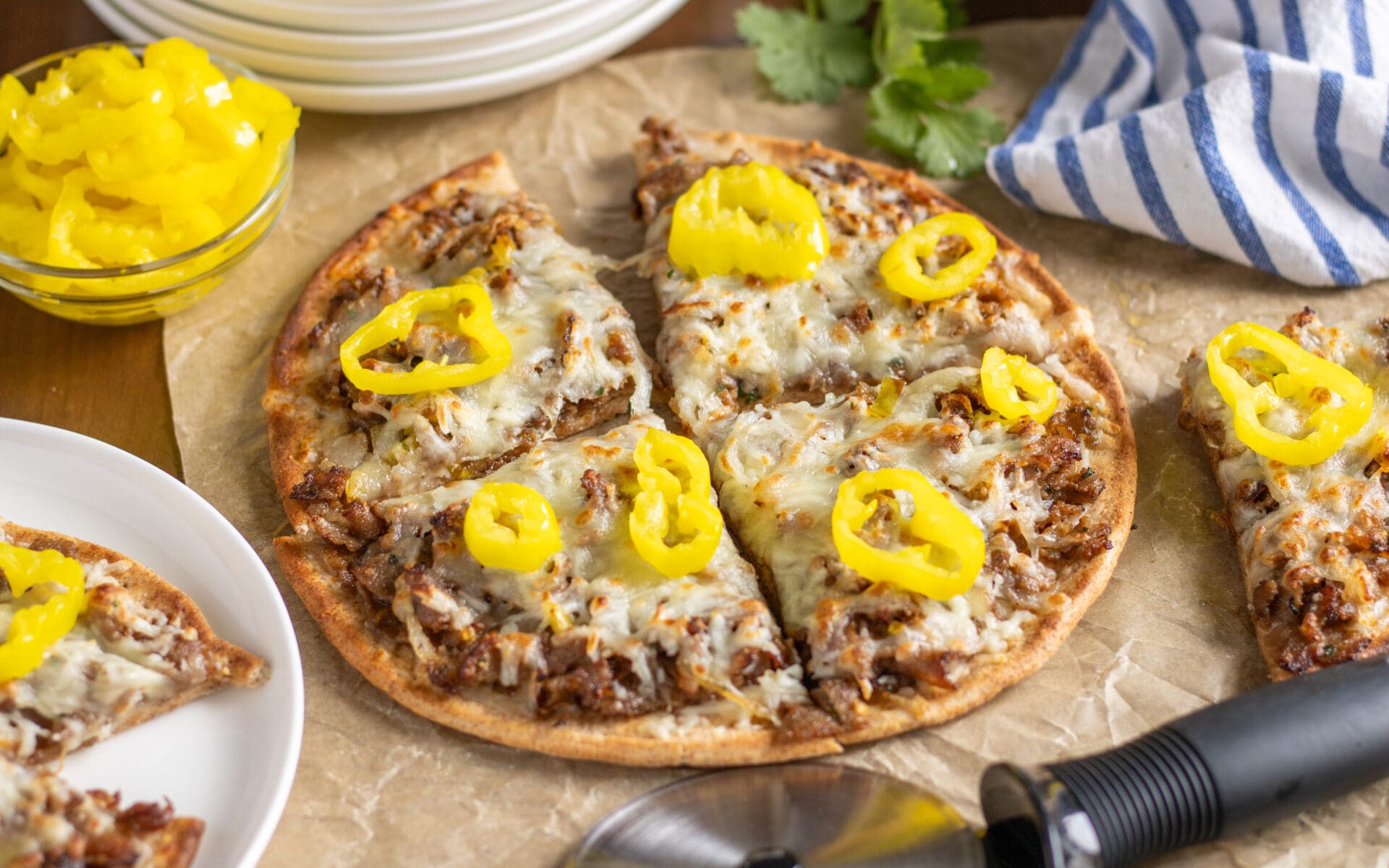 Philly Cheesesteak Pizza cut up on a serving tray.