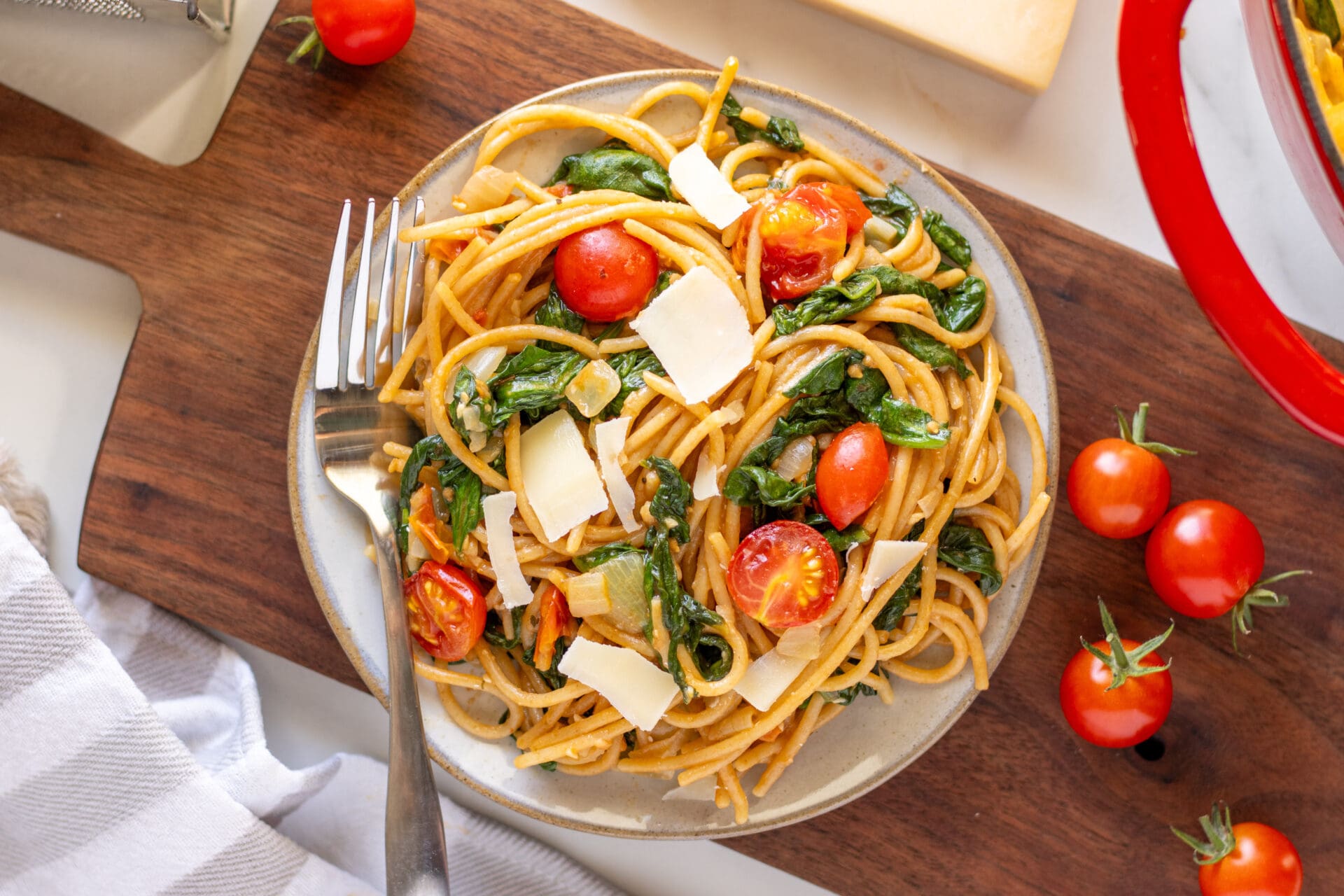 30-minute whole wheat garlic pasta in a dish with tomatoes around.